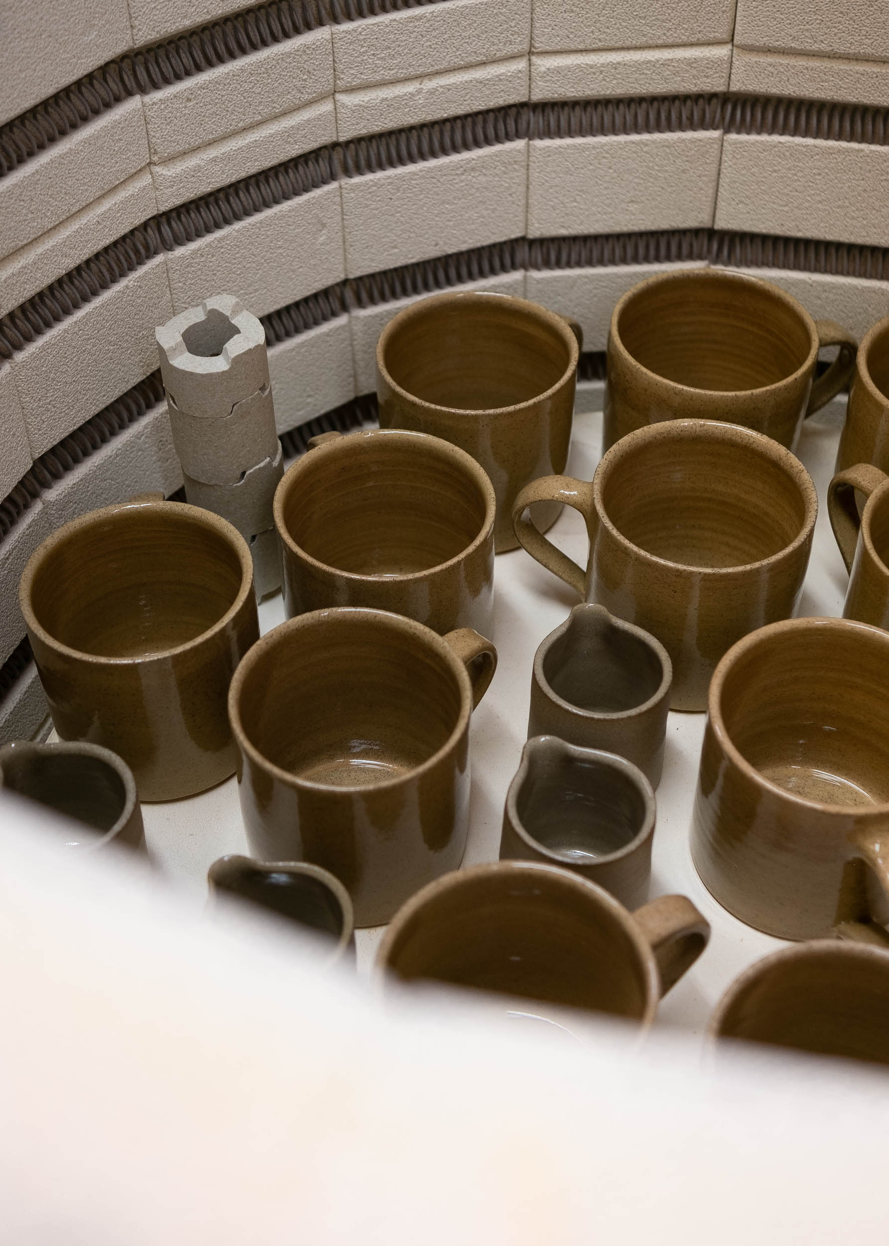 Brown mugs in a kiln